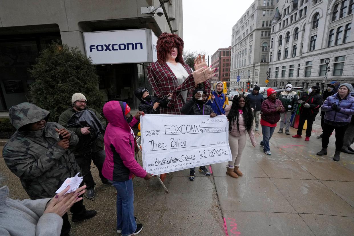 People protest with a makeshift puppet of former Lt. Gov. Rebecca Kleefisch and a check to Foxconn as part of a demonstration outside of Foxconn Wisconsin headquarters on East Wisconsin Ave. The Racine County Foxconn project has fallen far short of its promise of 13,000 jobs.
