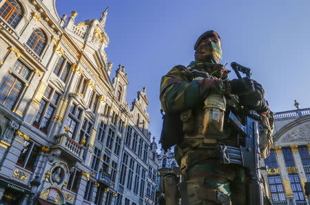 A Belgian soldier patrols in Brussels' Grand Place as police searched the area during a continued high level of security following the recent deadly Paris attacks, Belgium, November 23, 2015. REUTERS/Yves Herman