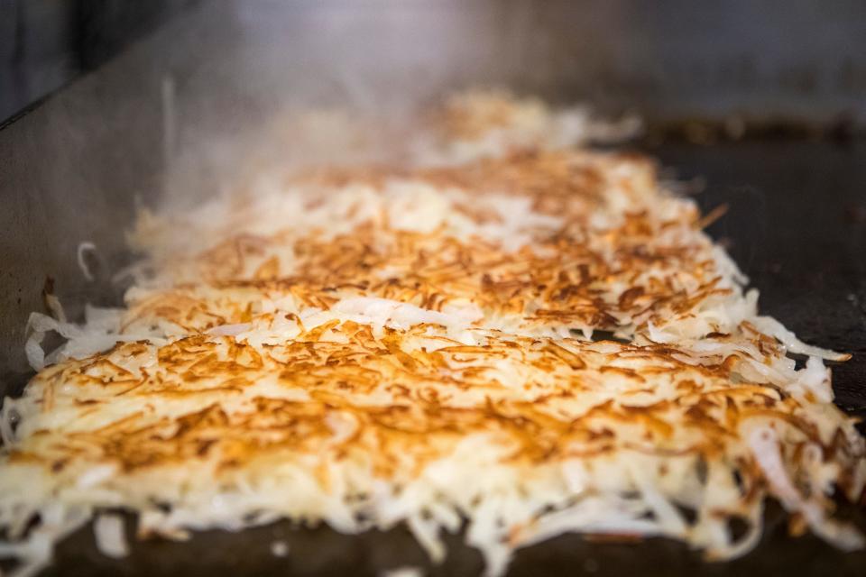 Another round of hash browns cooks on the griddle at Goober's Diner on May 17, 2021.