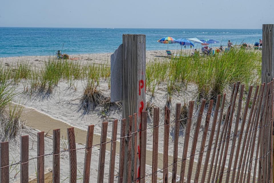 Homeowners who live near Charlestown Town Beach are trying to overturn the state's new shoreline-access law in court, arguing that it turns private property into public beaches, lowering their home values.