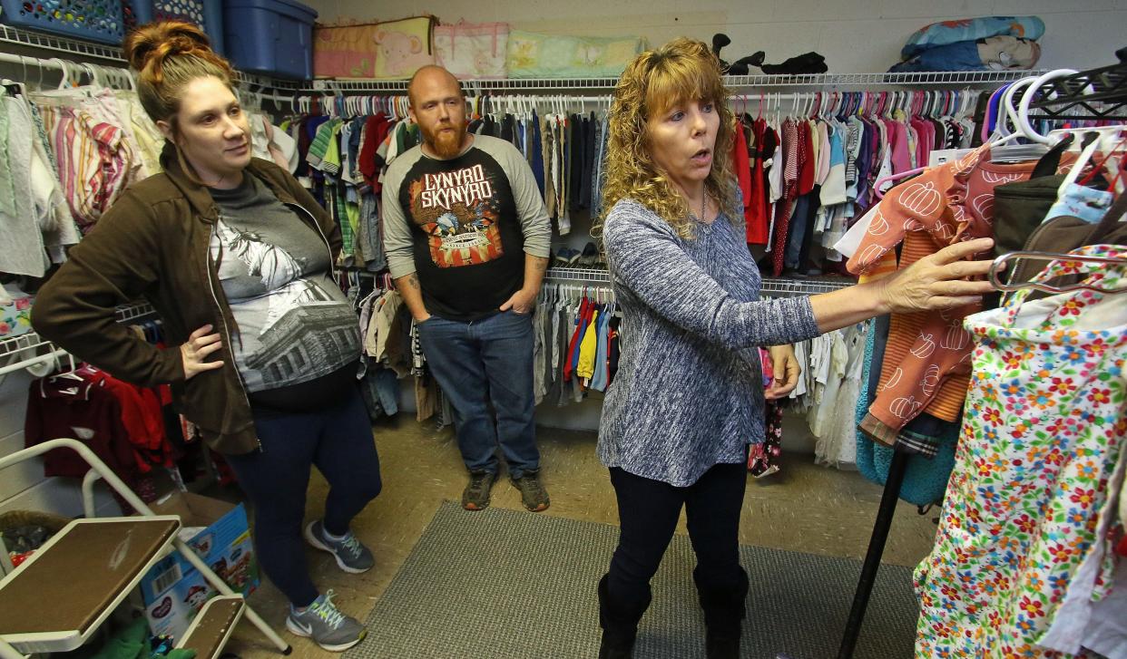 Jessica and Dustin Black get help from Chrissy Helton as the couple looks for children’s clothes Saturday morning, Nov. 20, 0221, at the infant and toddler clothing closet at Polkville Baptist Church.