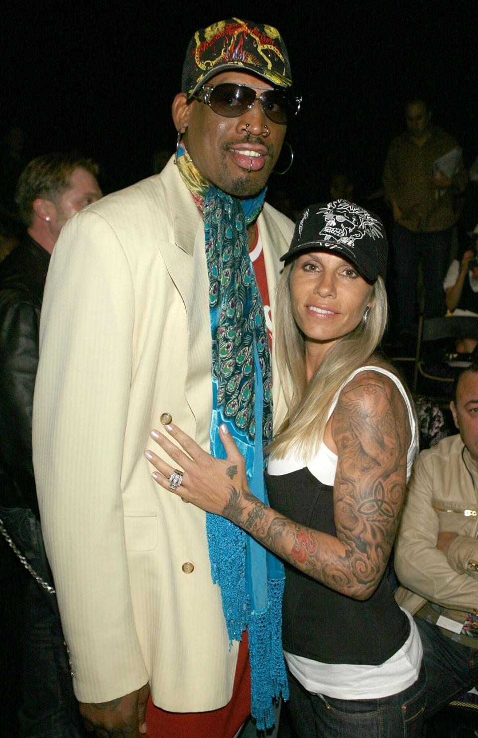 Dennis Rodman (L) and Michelle Moyer pose in the front row at the Christian Audigier Fall 2007 fashion show during Mercedes Benz Fashion Week held at Smashbox Studios on March 21, 2007 in Culver City, California