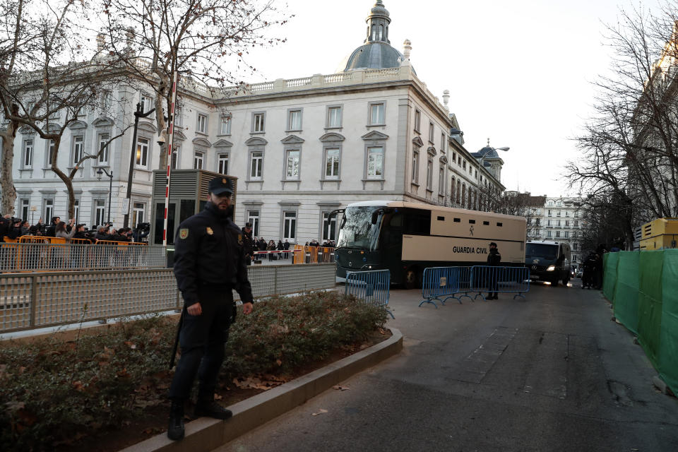 A bus belonging to Spain's Civil Guard allegedly carrying Catalonian politicians and activists, arrives at the Spanish Supreme Court in Madrid, Tuesday, Feb. 12, 2019. Spain is bracing for the nation's most sensitive trial in four decades of democracy this week, with a dozen Catalan separatists facing charges including rebellion over a failed secession bid in 2017. (AP Photo/Manu Fernandez)