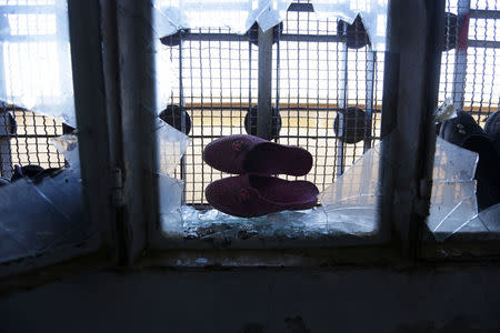 Students' shoes are seen on a broken window in 'Aisha Mother of the BelieversÕ school which was recently reopened after rebels took control of al-Rai town from Islamic State militants, Syria January 16, 2017. Picture taken January 16, 2017. REUTERS/Khalil Ashawi