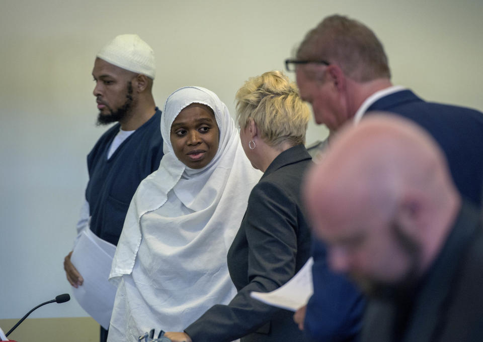 Siraj Ibn Wahhaj, from left, and Jany Leveille talk with with attorneys Kelly Golightley and Tom Clark after a hearing on a motion to dismiss in the Taos County Courthouse, Wednesday, Aug. 29, 2018. Judge Jeff McElroy ordered charges of neglect against both defendants dropped but the couple still face charges of child abuse resulting in death. In a separate hearing, Judge Emilio Chavez ordered neglect charges dropped on three other defendants due to a deadline missed by prosecutors. (Eddie Moore/The Albuquerque Journal via AP, Pool)