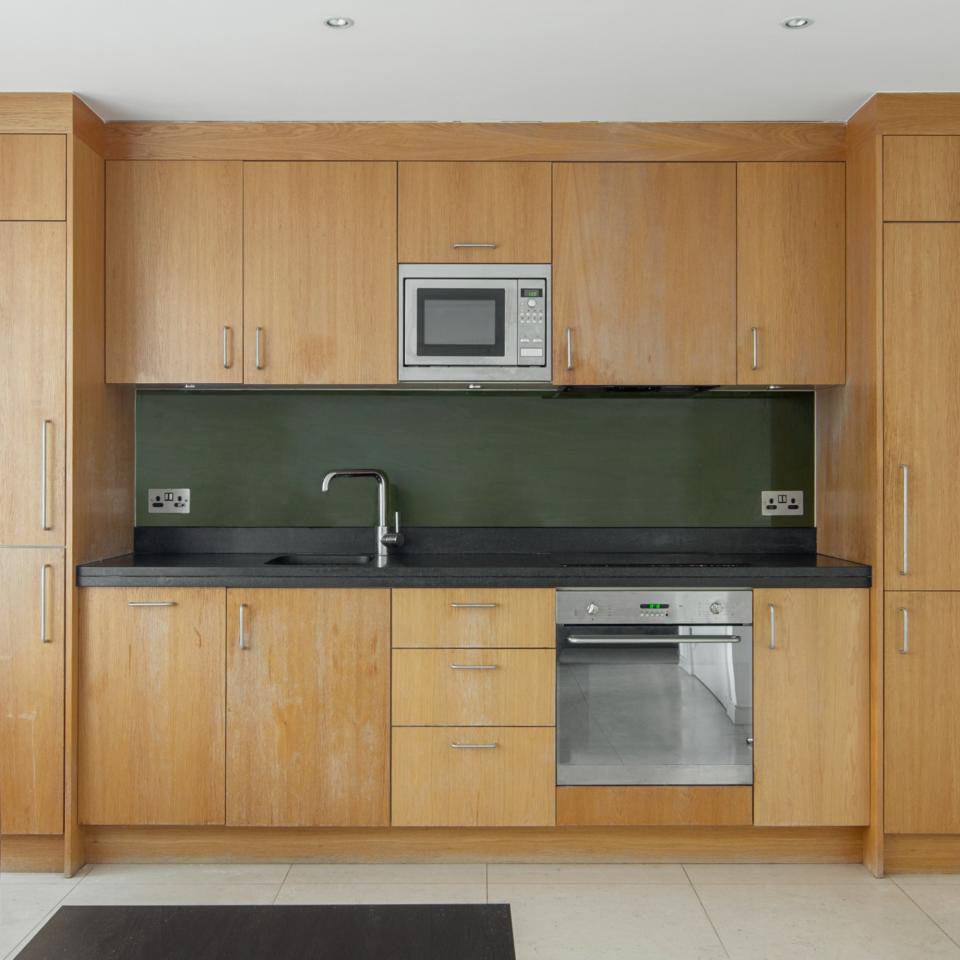 Wooden kitchen cabinets, sink, and countertop