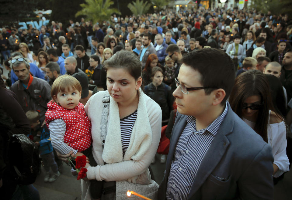 People wait during a vigil for slain television reporter Viktoria Marinova in Ruse, Bulgaria, Monday, Oct. 8, 2018. Bulgarian police are investigating the rape, beating and slaying of a female television reporter whose body was dumped near the Danube River after she reported on the possible misuse of European Union funds in Bulgaria (AP Photo/Vadim Ghirda)