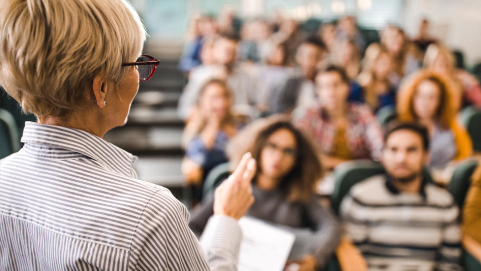 A female teacher in a classroom. Source: Getty stock.