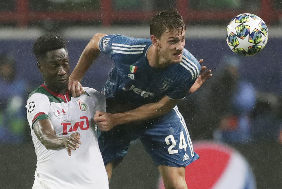 FILE - In this Nov. 6, 2019, file photo, Juventus' Daniele Rugani, right, fights for the ball with Lokomotiv's Eder during a Champions League soccer match at the Lokomotiv Stadium in Moscow, Russia. Italian soccer club Juventus announced on Wednesday, March 11, 2020, that defender Daniele Rugani has tested positive for new coronavirus. Rugani, who is also an Italy international, is the first player in Italy’s top soccer division to test positive but Juventus stressed that the 25-year-old has no symptoms. (AP Photo/Pavel Golovkin, File)