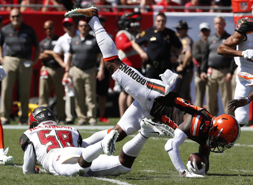 Cleveland Browns wide receiver Jarvis Landry (80) is upended by Tampa Bay Buccaneers outside linebacker Kwon Alexander (58) after a reception during the first half of an NFL football game Sunday, Oct. 21, 2018, in Tampa, Fla. (AP Photo/Mark LoMoglio)