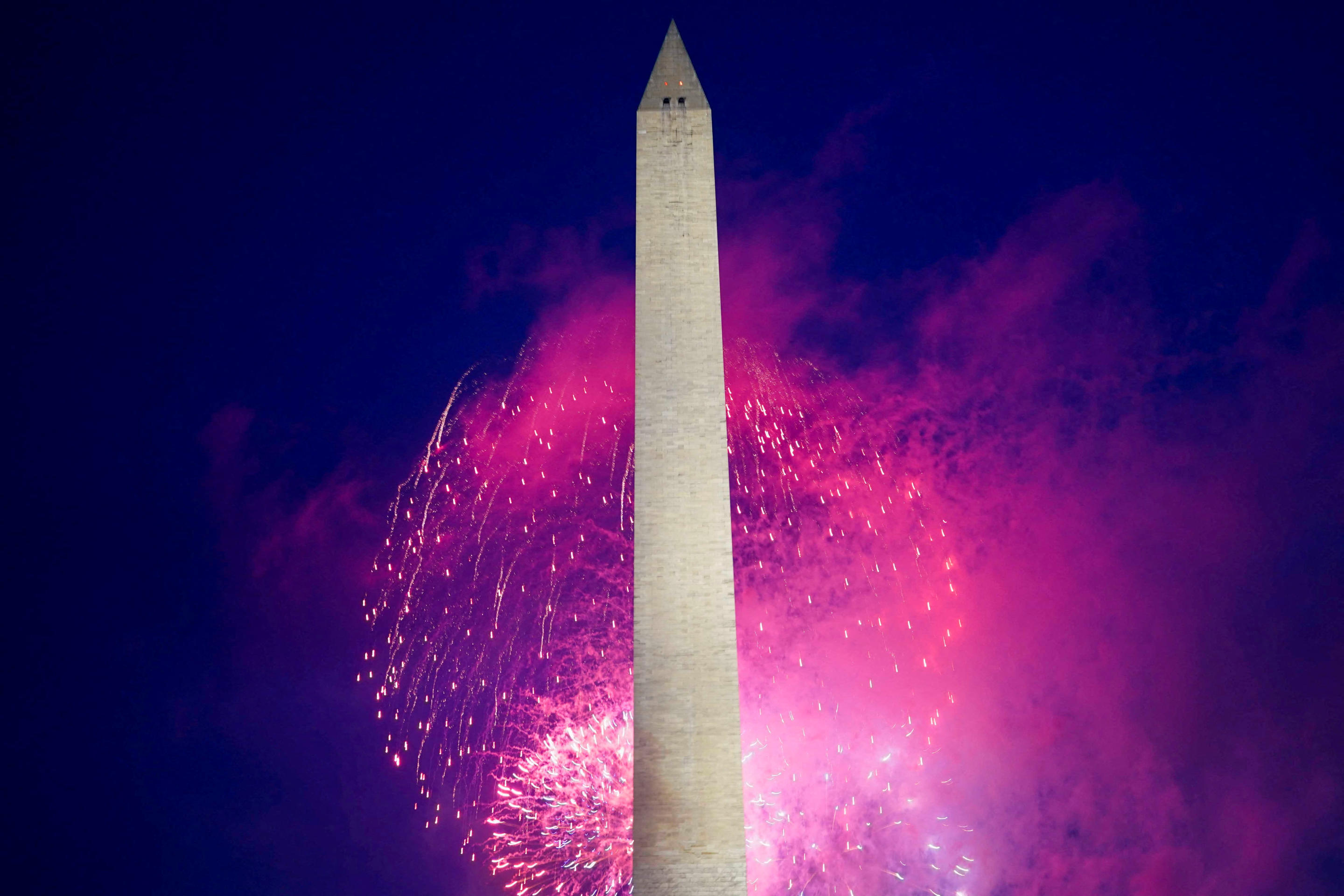 Fireworks explode near the Washington Monument.