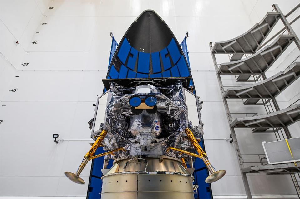 An image shows the Astrobotic lander positioned inside the ULA rocket. The rocket is halfway opened, revealing the lander.