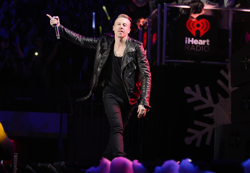 FILE - This Dec. 13, 2013 file photo shows Macklemore performing at Z100’s Jingle Ball 2013 in New York. The Seattle rapper was named The Source’s 2013 Man Of The Year. (Photo by Evan Agostini/Invision/AP, File)