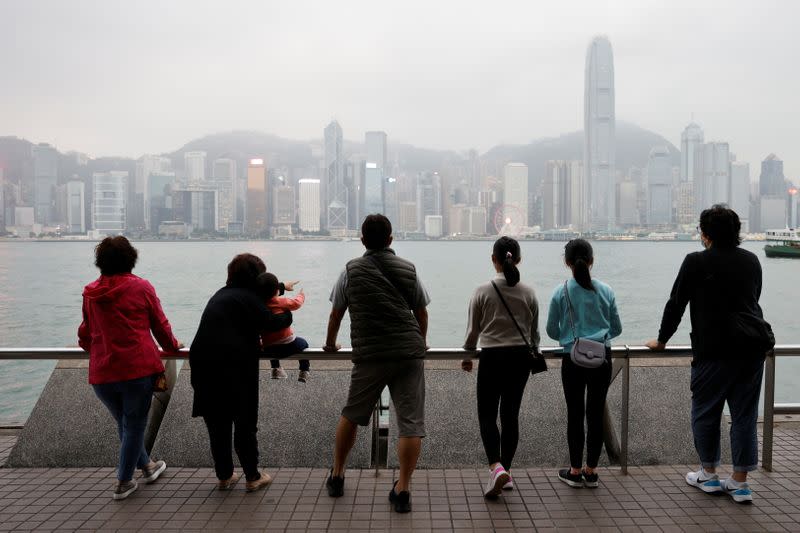 The Wider Image: Leaving Hong Kong: A family makes a wrenching decision