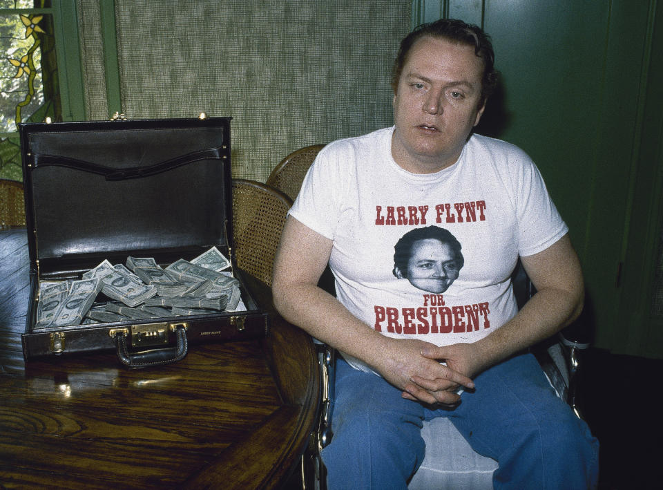 FILE - Publisher of "Hustler" magazine Larry Flynt is seen with a briefcase full of cash on Oct. 27, 1983, in Los Angeles. Flynt, who turned "Hustler" magazine into an adult entertainment empire while championing First Amendment rights, has died at age 78. His nephew, Jimmy Flynt Jr., told The Associated Press that Flynt died Wednesday, Feb. 10, 2021, of heart failure at his Hollywood Hills home in Los Angeles. (AP Photo/Wally Fong, File)