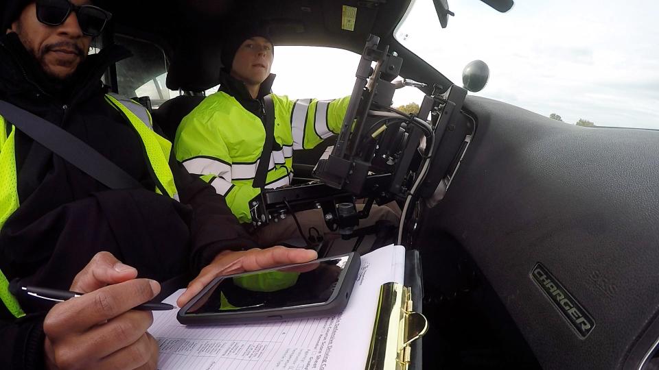 Kalib Manning, who is going through the Southern Tier Law Enforcement Academy in Elmira, checks the side mirrors as he weaves in and out of the cones in reverse while Officer Bryant Tranchant grades his driving skills. Manning willl be joining Tompkins County Sheriff's Department when he graduates the academy.