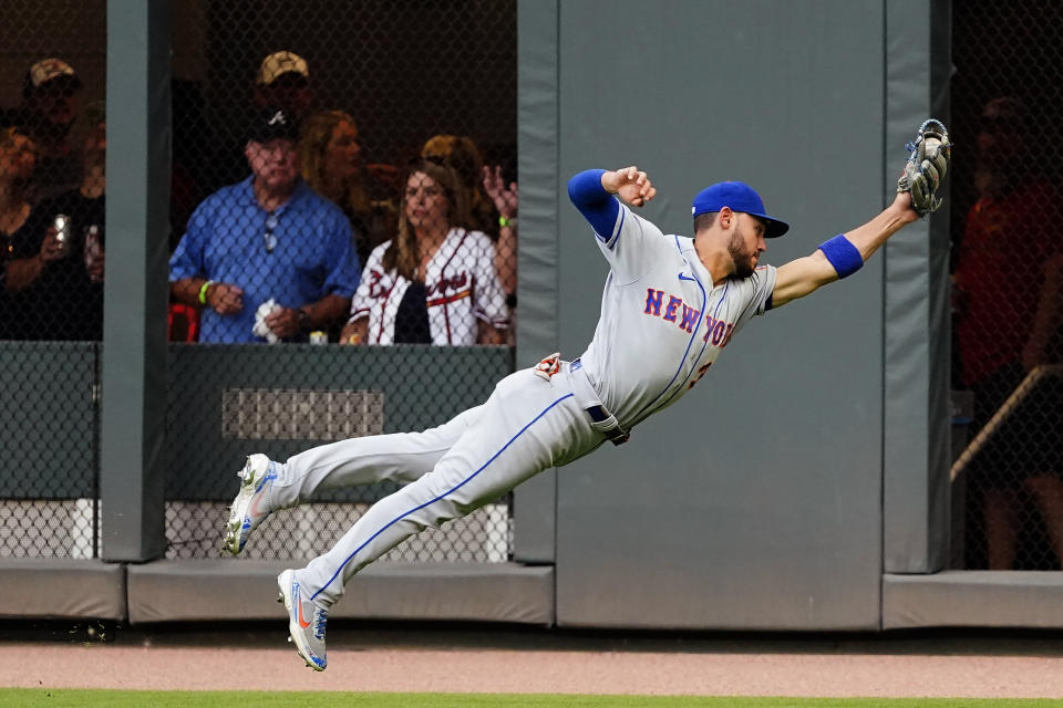 New York Mets right fielder Michael Conforto makes a diving catch on a fly ball from Atlanta Braves' Dansby Swanson during the first inning of a baseball game Wednesday, June 30, 2021, in Atlanta. (AP Photo/John Bazemore)