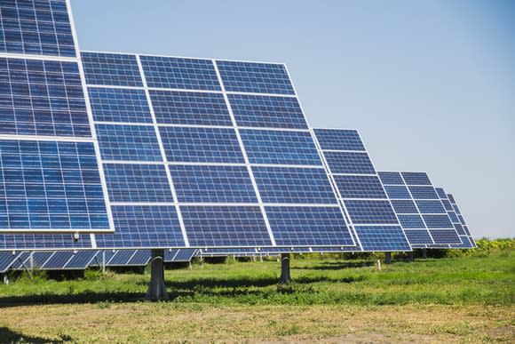 A field of solar panels on sun trackers.