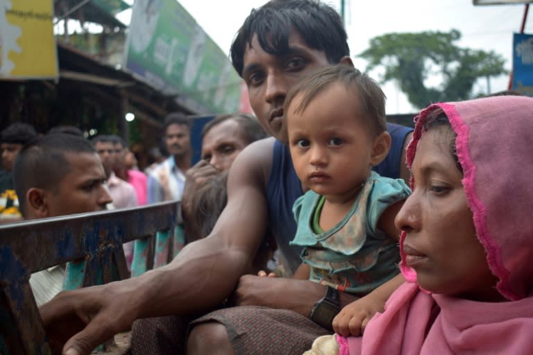 Rohingya refugees travel on an open-back truck near the Kutupalong refugee camp in Ukhiya, Bangladesh