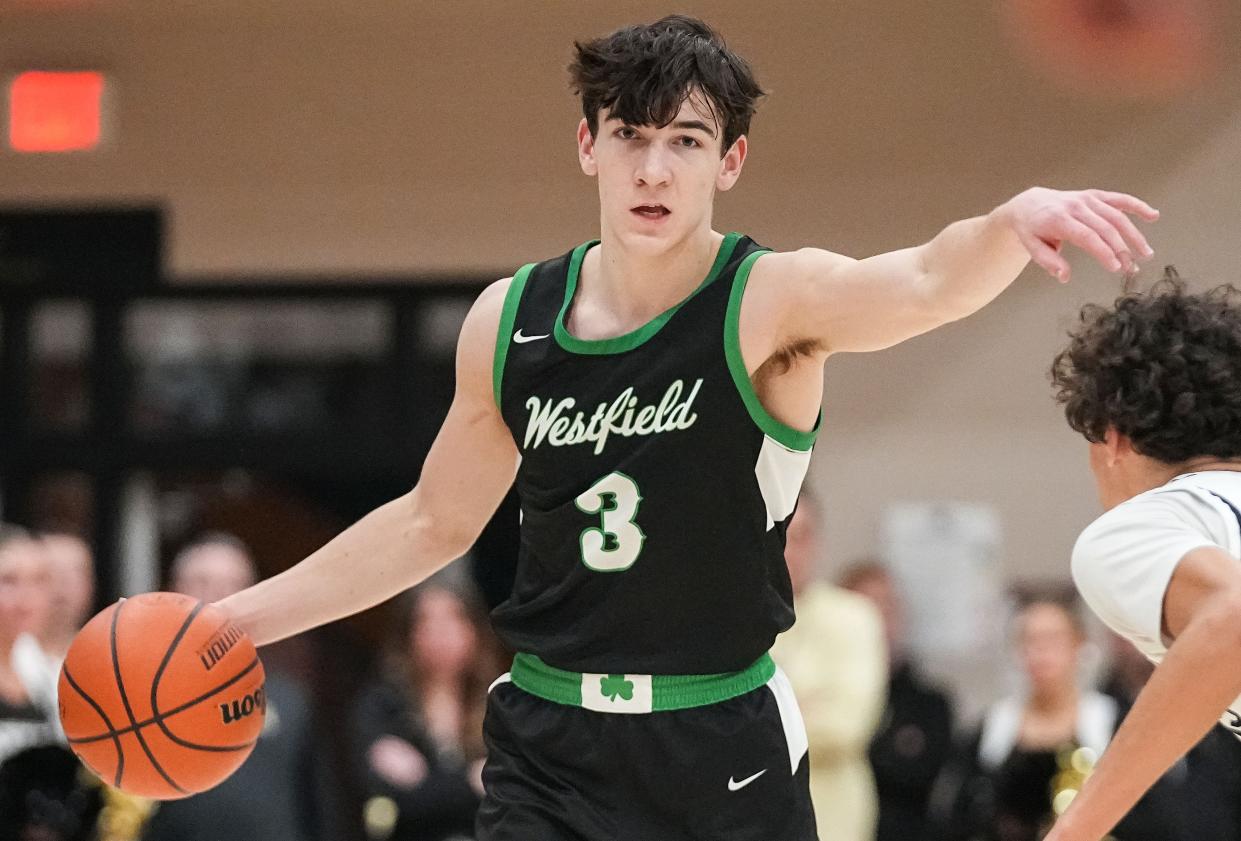 Westfield Shamrocks Trey Buchanan (3) points down he court Wednesday, Jan. 17, 2024, during the game at Noblesville High School in Noblesville. The Westfield Shamrocks defeated the Noblesville Millers, 58-54.