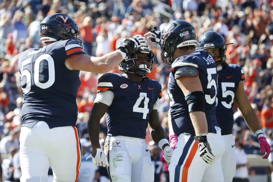 Oct 7, 2023; Charlottesville, Virginia, USA; Virginia Cavaliers wide receiver Malik Washington (4) celebrates with teammates after scoring a touchdown against the William & Mary Tribe during the second half at Scott Stadium. Mandatory Credit: Amber Searls-USA TODAY Sports