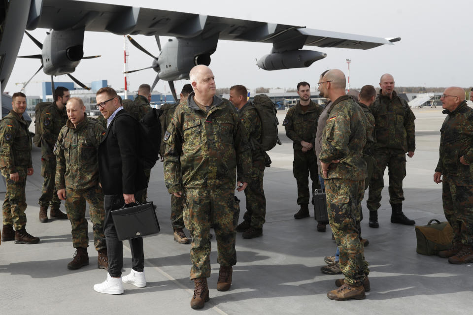 German Bundeswehr soldiers of the Headquarters initial command element of the Bundeswehr's 45th Brigade Lithuania arrive at an airport in Vilnius, Lithuania, Monday, April 8, 2024. Germany has made a commitment to deploy a heavy brigade with three maneuver battalions and all necessary enablers, including combat support and provision units, to Lithuania. In total, approx. 5 thousand German military and civilian personnel are expected to move to Lithuania with families in stationing the Brigade. (AP Photo/Mindaugas Kulbis)