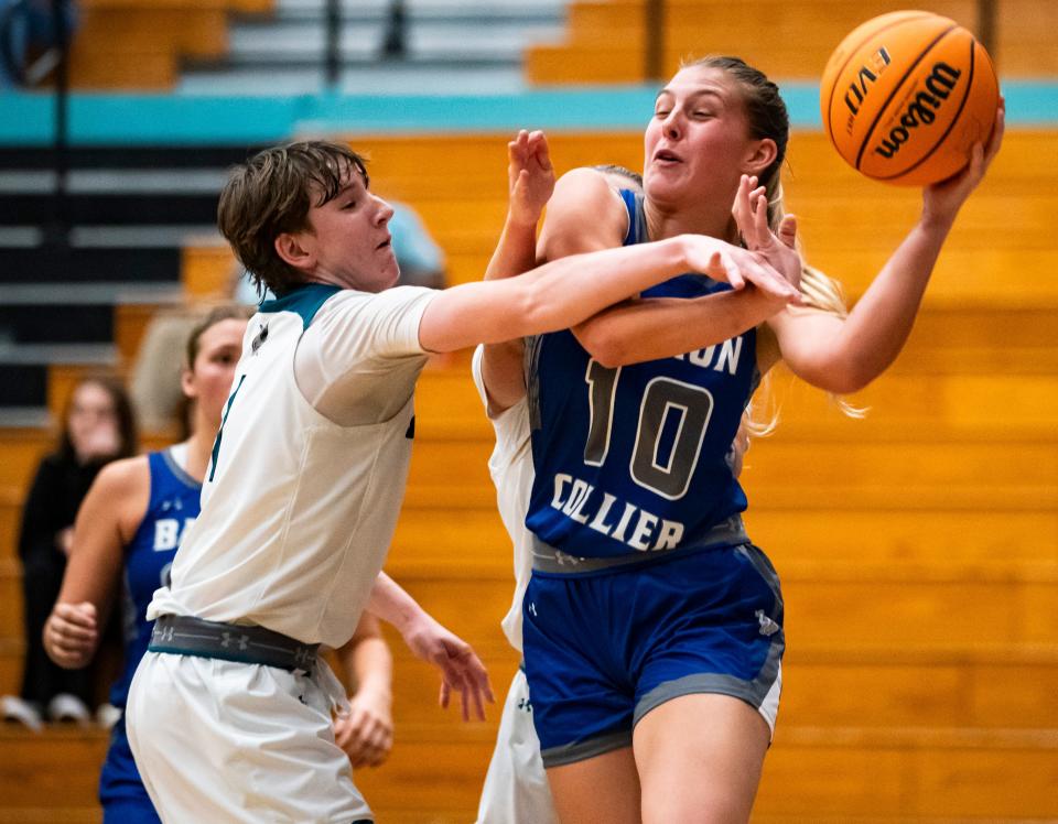 Barron Collier Cougars forward Regan Means (10) looks to pass while being guarded by Gulf Coast Sharks forward Mackenzie Mcmaster (1) during the second quarter of a game at Gulf Coast High School in Naples on Tuesday, Dec. 12, 2023.