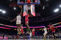 Philadelphia 76ers' James Harden, left, tries to get a shot past Chicago Bulls' Derrick Jones Jr. in double overtime of an NBA basketball game, Monday, March 20, 2023, in Philadelphia. (AP Photo/Matt Slocum)