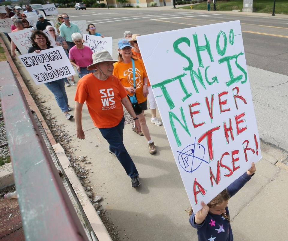 Marni Boyd, 8, holds the sign she made as she takes part in Walk for Our Lives walk against gun violence held Wednesday by members of the East Ohio Conference of the United Methodist Church.