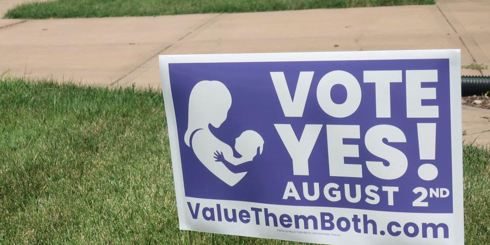 In this photo from Friday, July 8, 2022, a sign in a yard in Olathe, Kansas, promotes a proposed amendment to the Kansas Constitution to allow legislators to further restrict or ban abortion