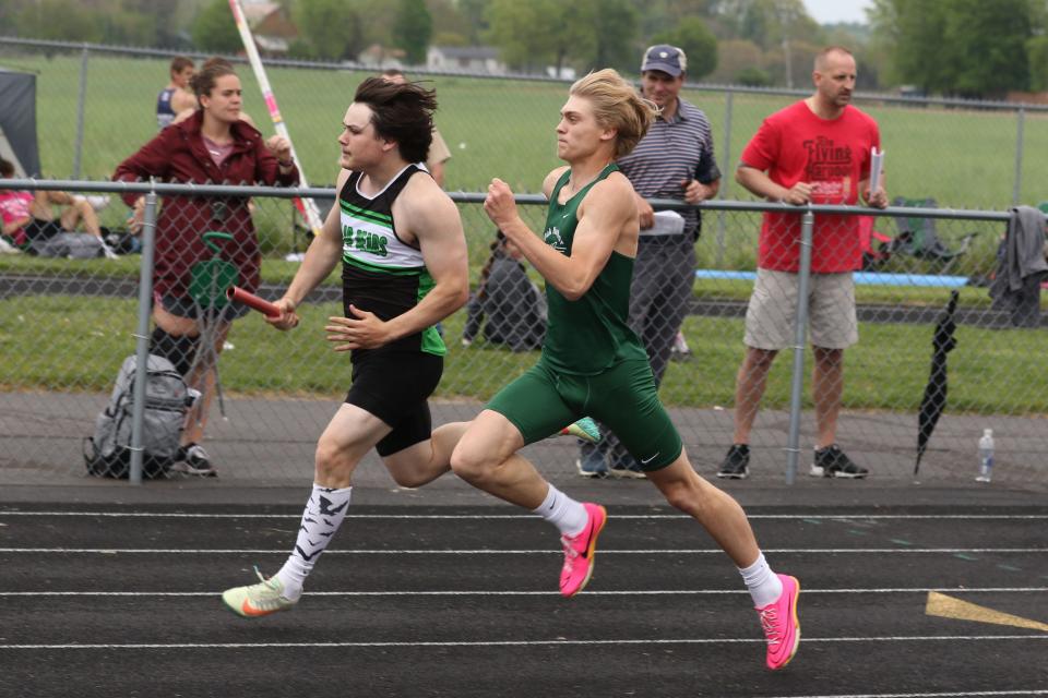 Margaretta's Kaine Smetzer and Oak Harbor's Owen Miller run the 4x200 relay.