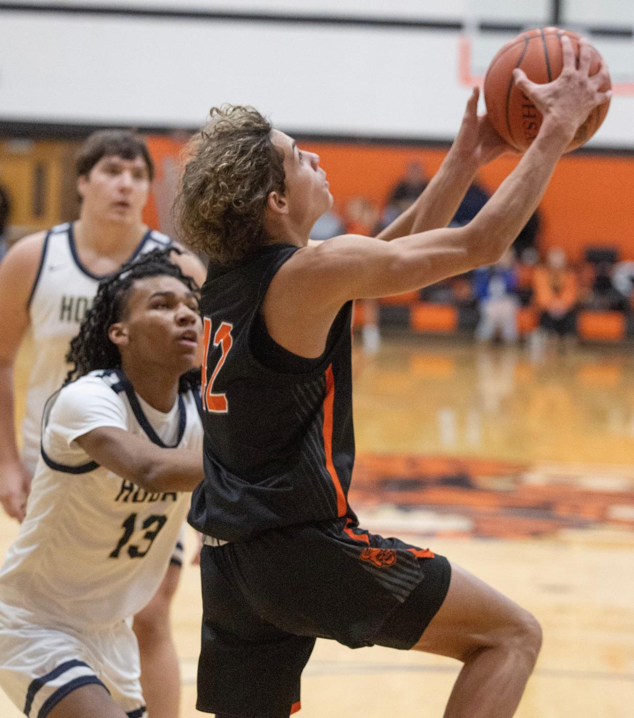 Hoover's Hunter Hershberger goes to the hoop in the first half with pressure from Hoban's Deron Jennings.