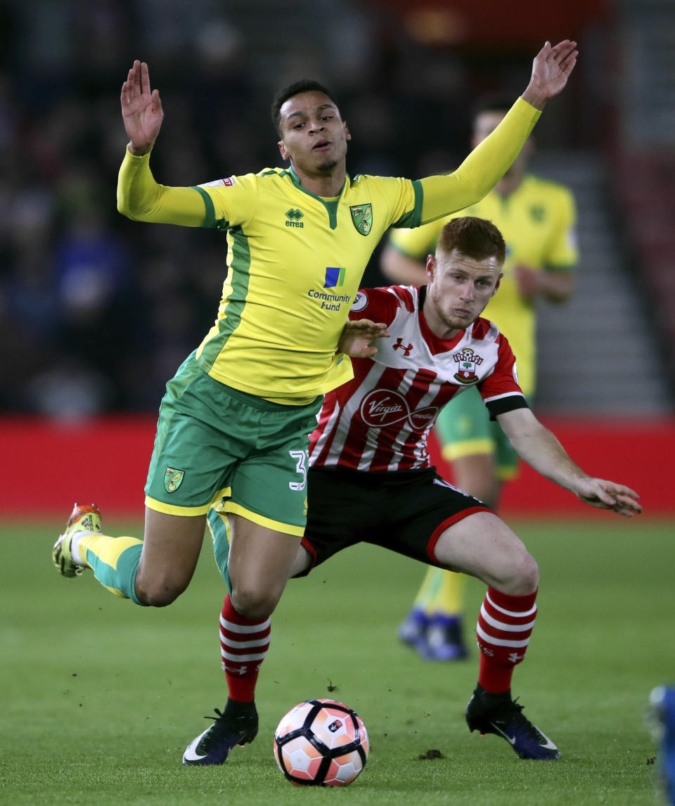 Norwich City's Josh Murphy, left, and Southampton's Harrison Reed battle for the ball during the English FA Cup, third round replay match at St Mary's, Southampton, England Wednesday Jan. 18, 2017. (Nick Potts/PA via AP)