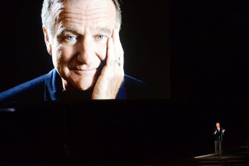 Robin Williams is seen on screen as Billy Crystal speaks during an In Memoriam tribute during the Primetime Emmy Awards at the Nokia Theatre in Los Angeles in 2014. File Photo by Pat Benic/UPI