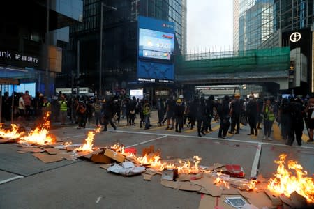 Protestors leave after lighting fire on a road during a rally in Hong Kong