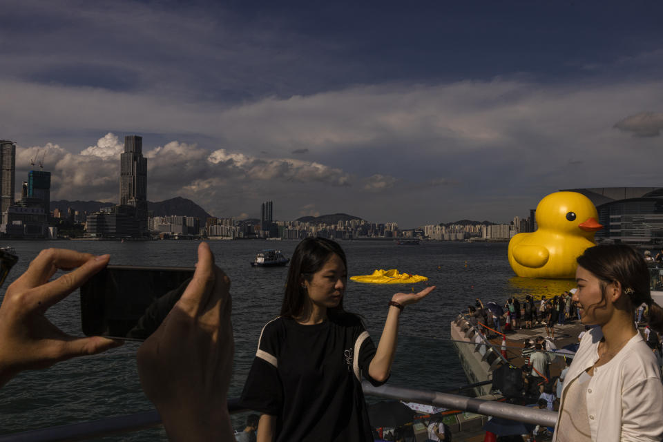 An art installation called "Double Ducks" by Dutch artist Florentijn Hofman as one of the duck is deflated at Victoria Harbour in Hong Kong, Saturday, June 10, 2023. (AP Photo/Louise Delmotte)