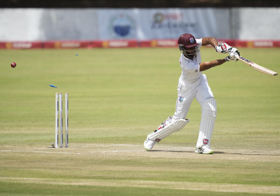 West Indies batsman Roston Chase is bowled out on the second day of the second Test cricket match between Zimbabwe and West Indies at Queens Sports Club in Bulawayo, Zimbabwe, Monday, Feb. 13, 2023. (AP Photo/Tsvangirayi Mukwazhi)