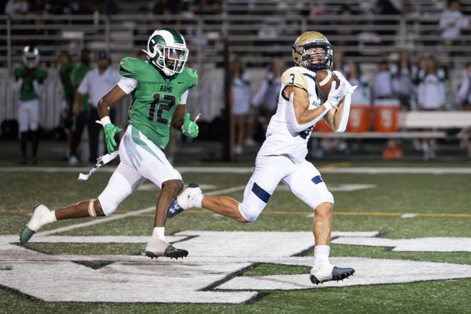 Central Catholic’s Trace Hernandez makes a catch past St. Mary’s defender Brilan Reynolds and runs in for a touchdown during the game at St. Mary’s High School in Stockton, Calif., Friday, August 25, 2023.