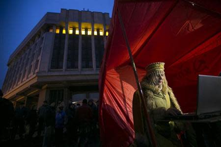 A pro-Russian DJ in traditional clothing looks at her computer during a rally outside the Crimean parliament building in Simferopol February 27, 2014. REUTERS/Baz Ratner