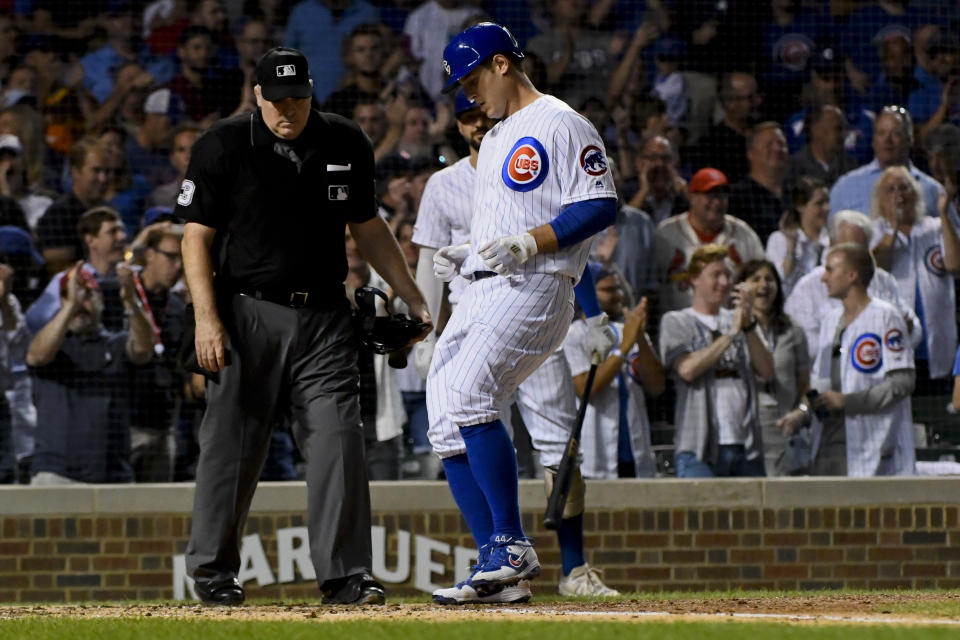 Chicago Cubs' Anthony Rizzo, center, crosses home plate after hitting a home run against the St. Louis Cardinals during the third inning of a baseball game Thursday, Sept. 19, 2019, in Chicago. (AP Photo/Matt Marton)