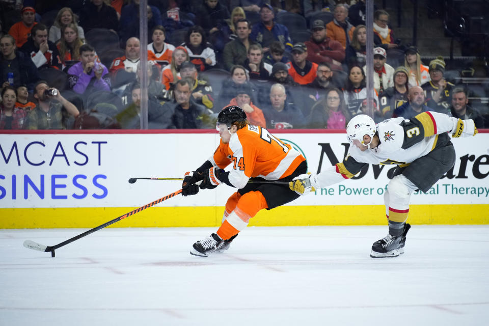 Philadelphia Flyers' Owen Tippett, left, tries to get past Vegas Golden Knights' Brayden McNabb during the second period of an NHL hockey game, Tuesday, March 14, 2023, in Philadelphia. (AP Photo/Matt Slocum)