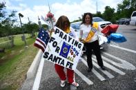 <p>Residents bring memorial items to Santa Fe High School on May 19, 2018 in Santa Fe, Texas. (Photo : Brendan Smialowski/AFP/Getty Images) </p>