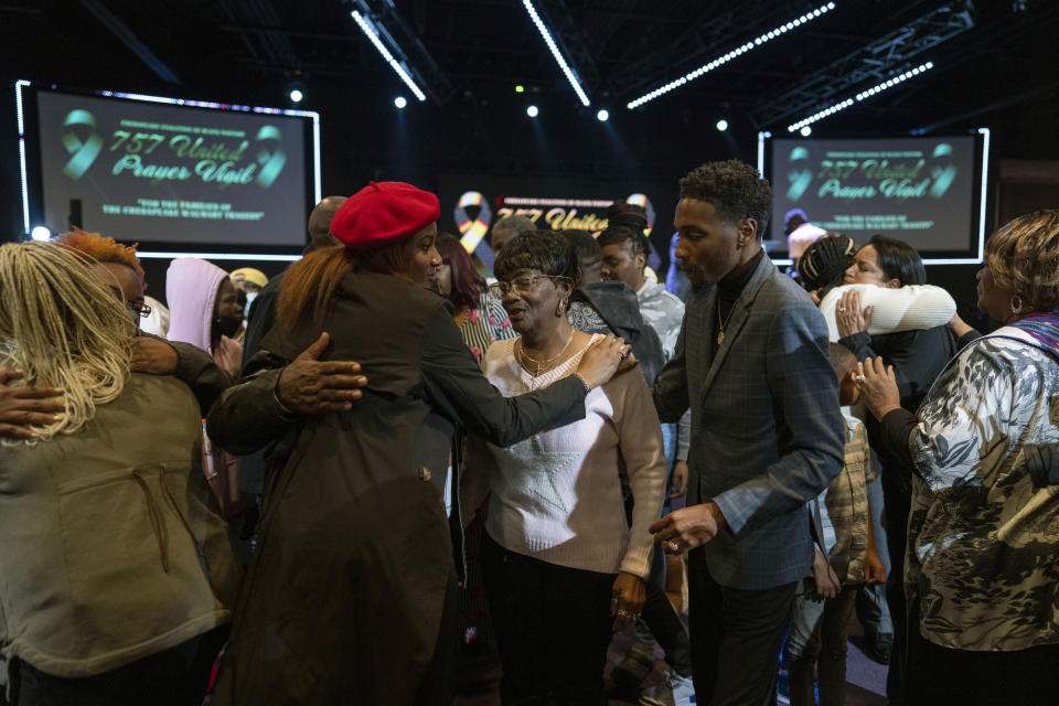 Linda Gamble, center, mother of Lorenzo Gamble, 43, of Chesapeake, Va., is comforted during a prayer vigil held by the Chesapeake Coalition of Black Pastors at The Mount (Mount Lebanon Baptist Church) in Chesapeake, Va., Sunday, Nov. 27, 2022, for the six people killed at a Walmart in Chesapeake, Va., including Lorenzo Gamble, when a manager opened fire with a handgun before an employee meeting Tuesday night. (AP Photo/Carolyn Kaster)