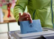 A woman casts her vote during regional elections at a polling station in Bad Kreuznach, in the German federal state of Rhineland-Palatinate, March 13, 2016. REUTERS/Kai Pfaffenbach