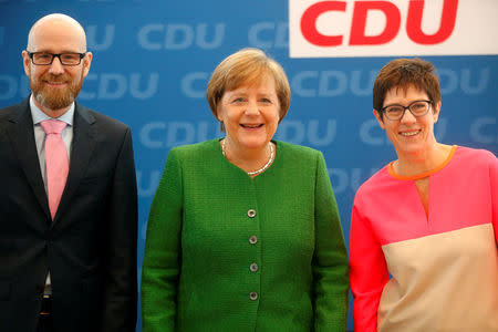 Secretary General of the Christian Democratic Union (CDU) Peter Tauber, German Chancellor Angela Merkel and Saarland State Prime Minister Annegret Kramp-Karrenbauer ahead CDU leadership meeting in Berlin, Germany, February 19, 2018. REUTERS/Hannibal Hanschke