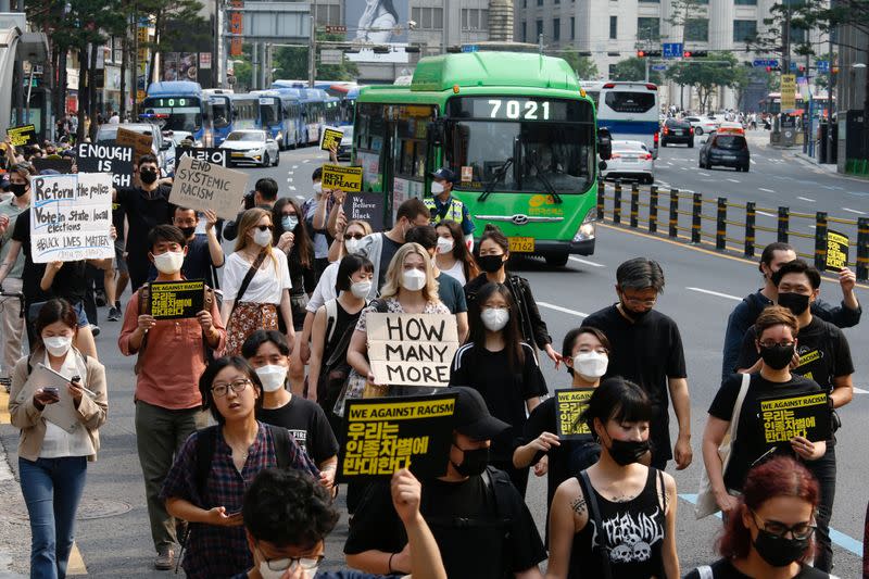 People march on the street in solidarity with protests against the death in Minneapolis police custody of George Floyd in Seoul