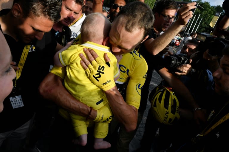 Tour de France 2016's winner Great Britain's Chris Froome (C) celebrates with his wife Michelle Cound (L) and their baby Kellan