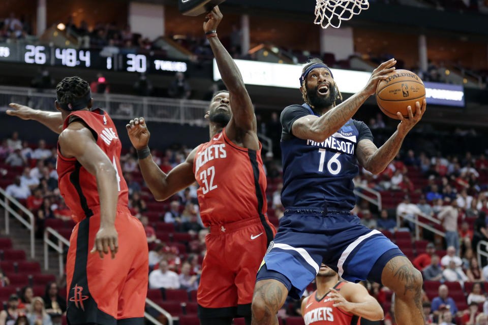 FILE - In this March 10, 2020, file photo, Minnesota Timberwolves forward James Johnson (16) shoots after getting past Houston Rockets forwards Danuel House Jr., left, and Jeff Green (32) during the first half of an NBA basketball game in Houston. Luca Doncic's first experience with the playoffs ended with questions about whether Marcus Morris of the Los Angeles Clippers was intentionally trying to hurt the young Dallas sensation. The Mavericks might have hinted at what they thought through trades and draft picks during this abbreviated offseason. Dallas acquired Johnson and his black belt in karate from the Oklahoma City Thunder after using the club's first-round choice at No. 18 overall on Josh Green, who was a strong defender in his only season at Arizona. (AP Photo/Michael Wyke, File)