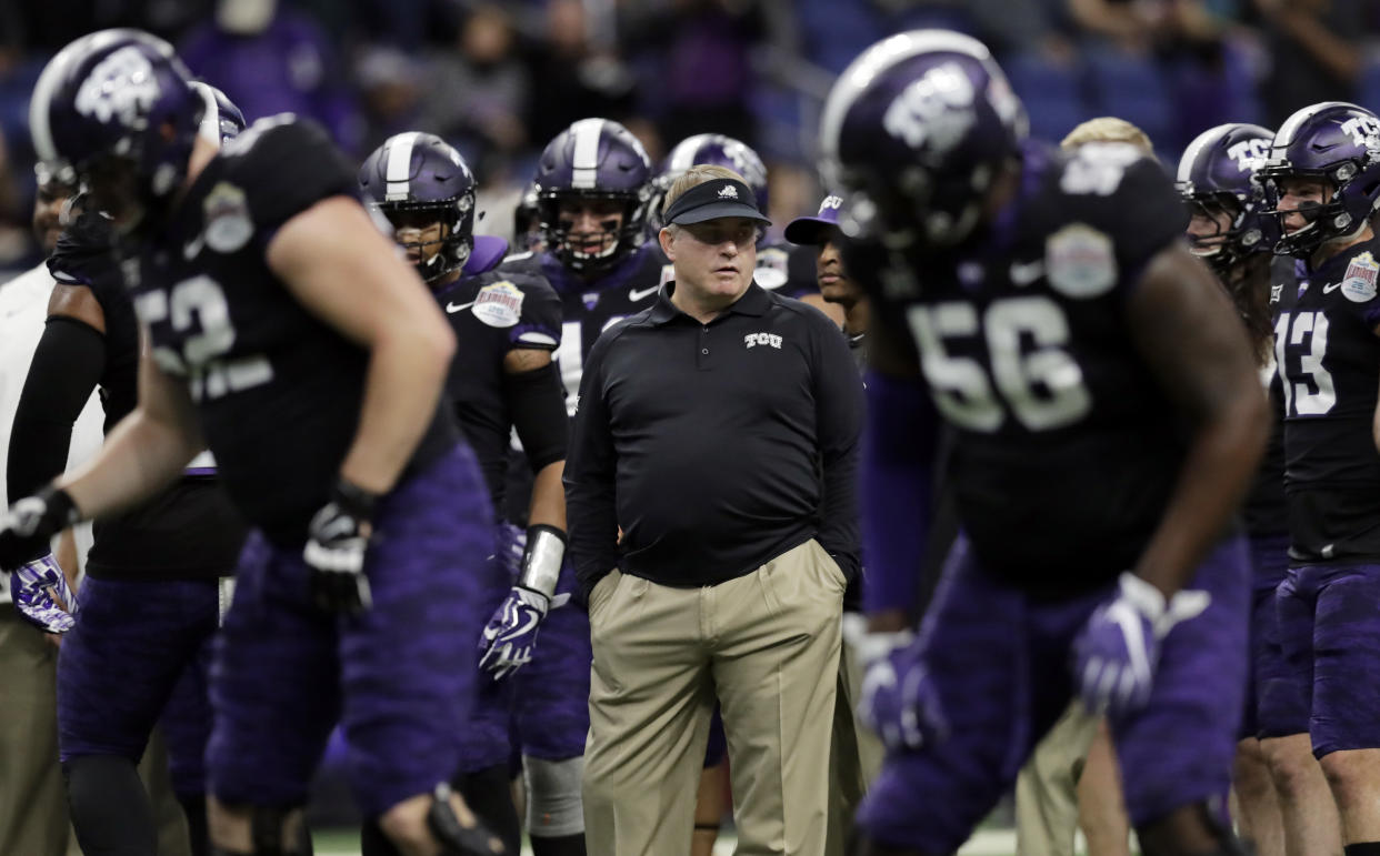 TCU head coach Gary Patterson, center, watches his team warm up before the Alamo Bowl NCAA college football game against Stanford , Thursday, Dec. 28, 2017, in San Antonio. (AP Photo/Eric Gay)