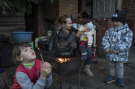 Margaryta Tkachenko, 29 years old, feeds her 9-month-old daughter Sophia in the recently retaken town of Izium, Ukraine, Sunday, Sept. 25, 2022. (AP Photo/Evgeniy Maloletka)